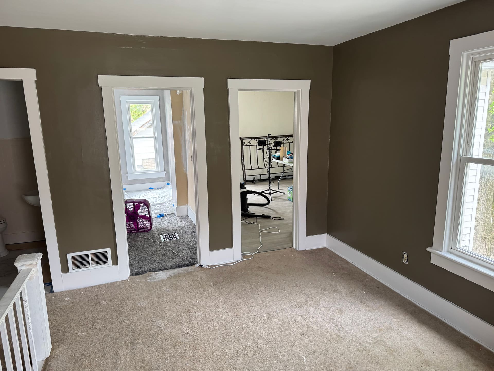 Upstairs room repainted in tan with clean white trim