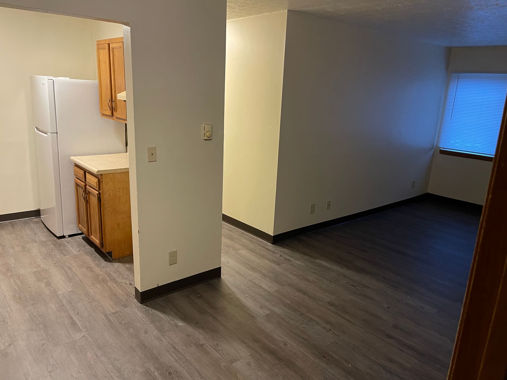 Apartment unit with new grey vinyl plank flooring after a full turnover