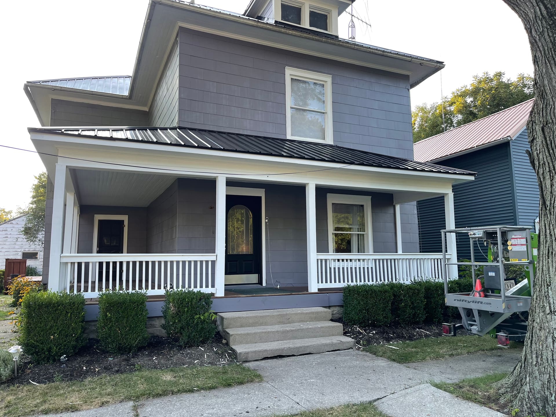 Two-story gray exterior repaint, detail angle on the freshly painted front